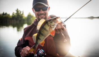 happy,angler,with,perch,fishing,trophy.