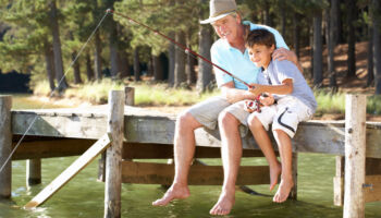 senior,man,fishing,with,grandson